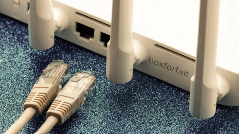 « Gros plan sur un routeur Wi-Fi blanc avec câbles Ethernet RJ45, illustrant les meilleures offres de box internet pas chères en 2026. »